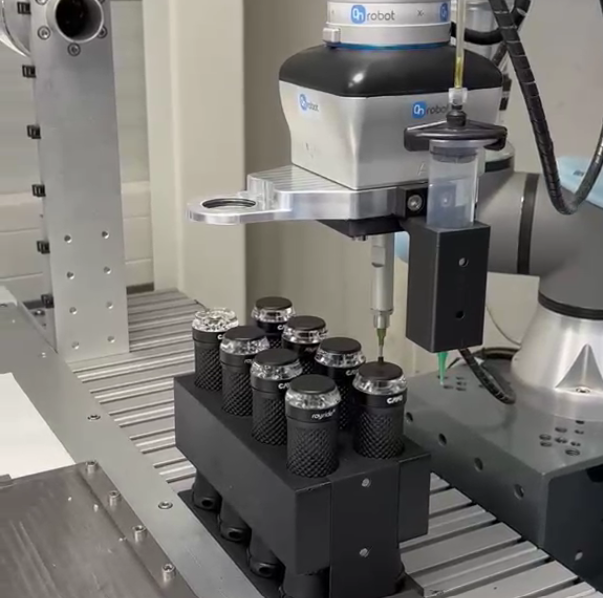 Collaborative robot gripper picking small parts from a fixture on a conveyor