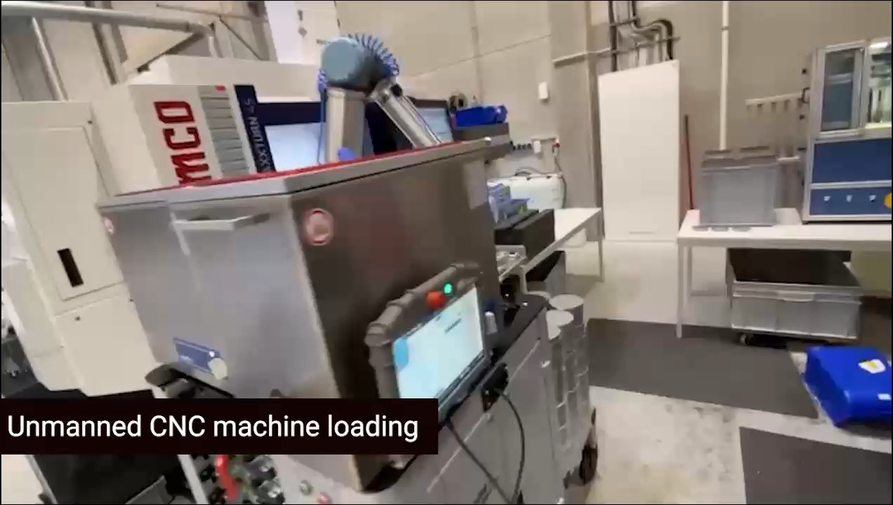 Collaborative robot loading a CNC machine, still frame from project footage